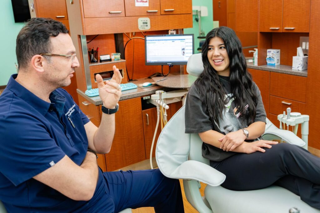 The top Boerne dentist talking with patient.