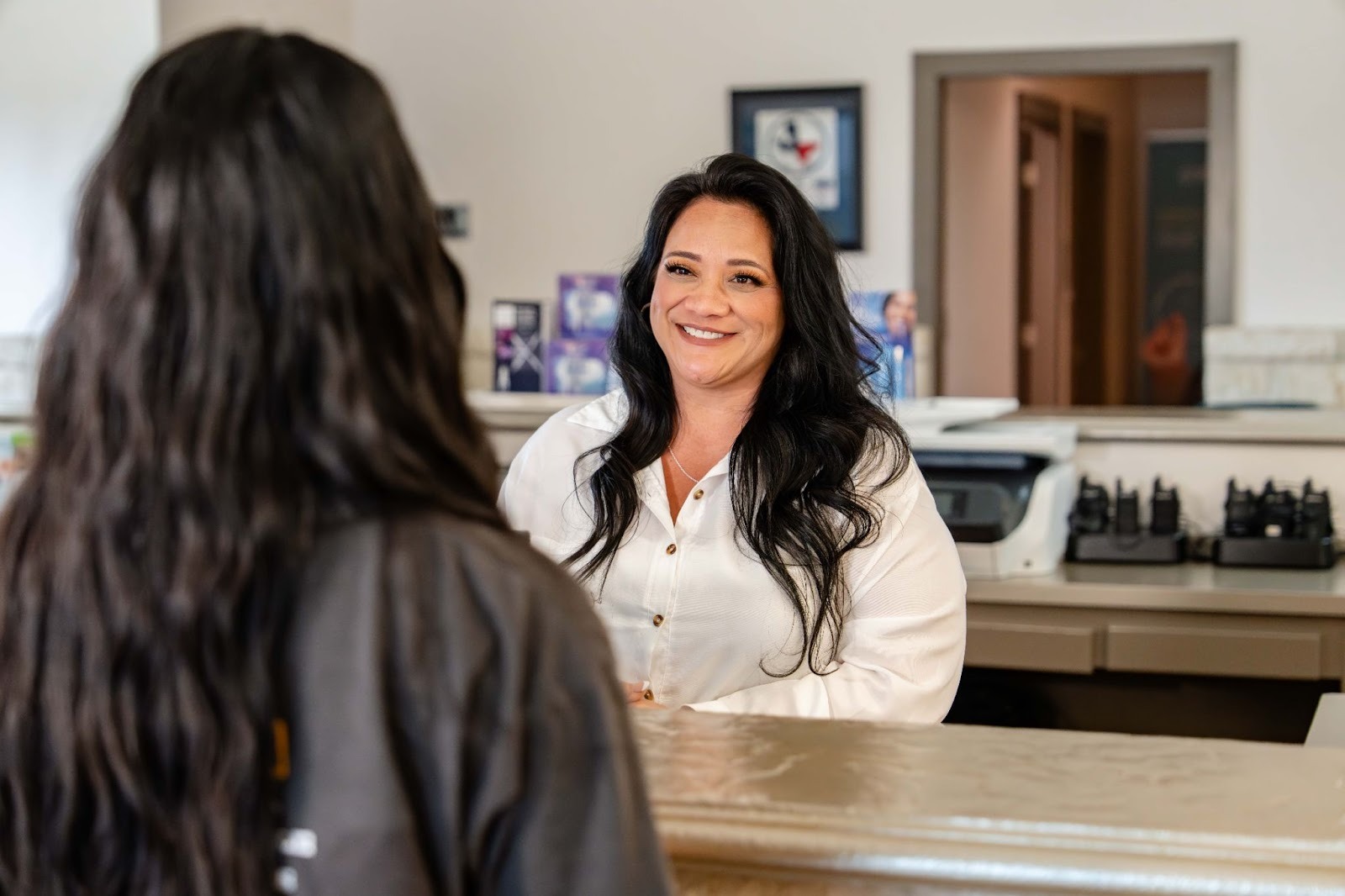 Smiling dental receptionist engaging with a patient at Complete Dental Studio in Boerne, TX, showcasing a welcoming environment for family dental care.